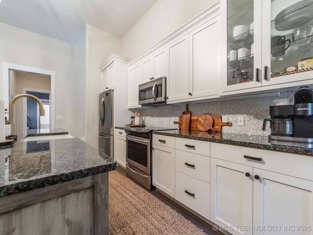 31 Park St, Carlton Landing, OK 74432 - kitchen with tasteful backsplash, dark stone countertops, appliances with stainless steel finishes, and a sink
