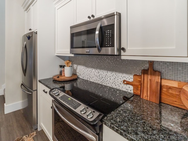 31 Park St, Carlton Landing, OK 74432 - kitchen featuring white cabinets, dark wood-style floors, dark stone counters, tasteful backsplash, and appliances with stainless steel finishes