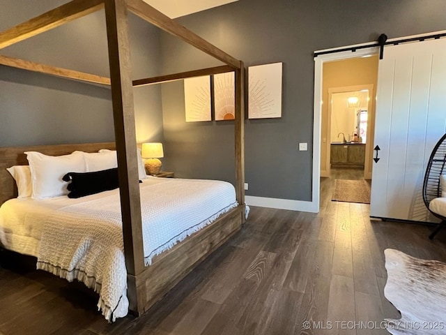 31 Park St, Carlton Landing, OK 74432 - bedroom with baseboards, vaulted ceiling, wood finished floors, and a barn door