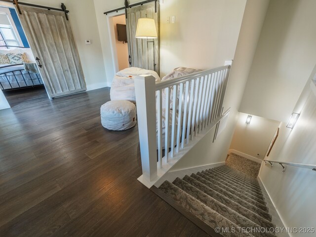31 Park St, Carlton Landing, OK 74432 - stairway with a barn door, baseboards, and wood finished floors