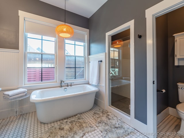 31 Park St, Carlton Landing, OK 74432 - full bath with tile patterned floors, a stall shower, a freestanding tub, a wainscoted wall, and toilet