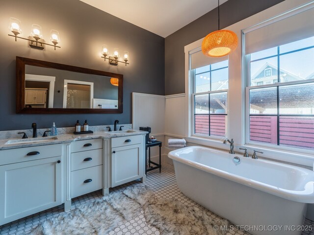 31 Park St, Carlton Landing, OK 74432 - bathroom with wainscoting, a freestanding tub, a sink, and double vanity