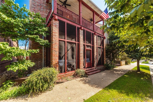 31 Park St, Carlton Landing, OK 74432 - view of exterior entry featuring a ceiling fan, a balcony, and brick siding