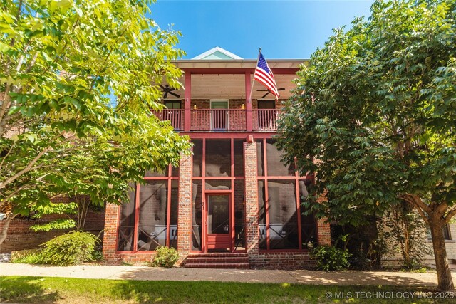 31 Park St, Carlton Landing, OK 74432 - view of front of house with brick siding, a balcony, and entry steps