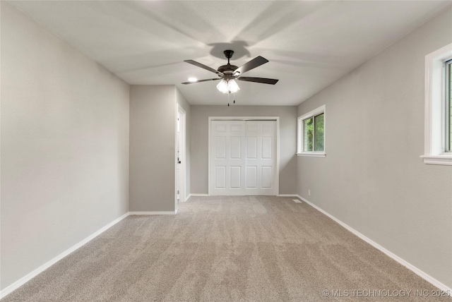 8219 S 67th W Ave, Tulsa, OK 74066 - unfurnished bedroom with carpet floors, baseboards, a ceiling fan, and a closet