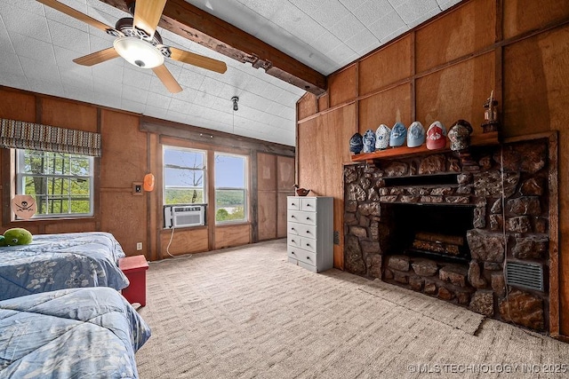 bedroom featuring a stone fireplace, vaulted ceiling with beams, wooden walls, cooling unit, and carpet