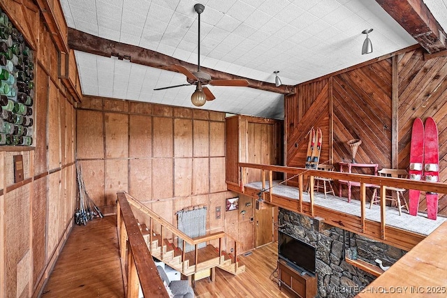 living area featuring wooden walls and wood finished floors