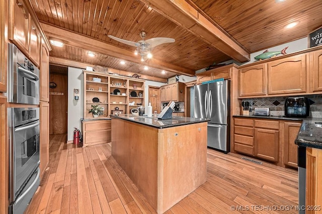 kitchen with wood ceiling, a center island, appliances with stainless steel finishes, and light wood finished floors