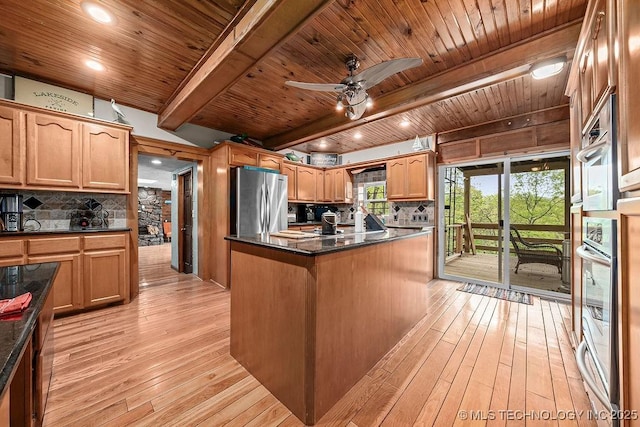 kitchen with tasteful backsplash, a center island, stainless steel appliances, light wood-style flooring, and wooden ceiling
