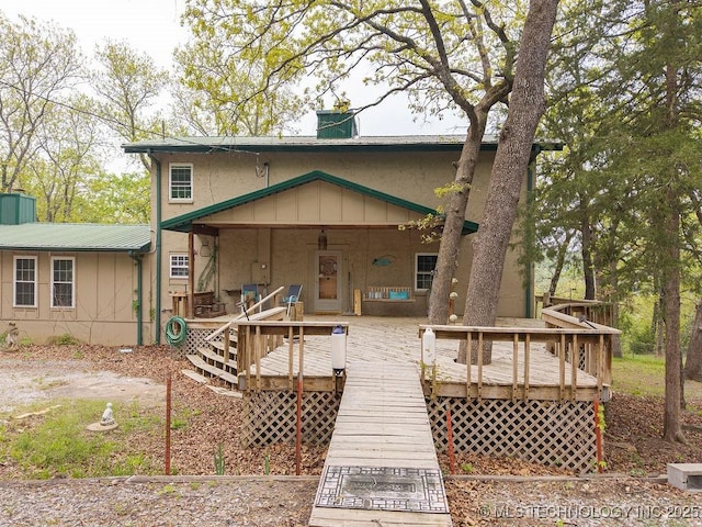 view of front of property with a chimney and stucco siding