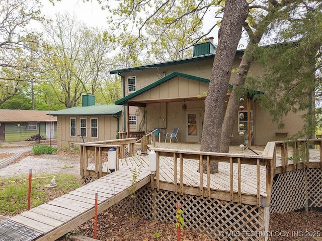 exterior space featuring a chimney and a wooden deck