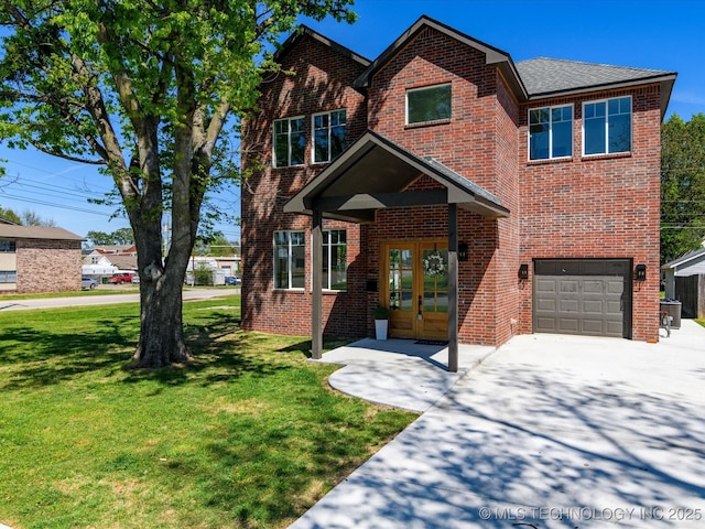 view of front of house with a front lawn, an attached garage, driveway, french doors, and brick siding