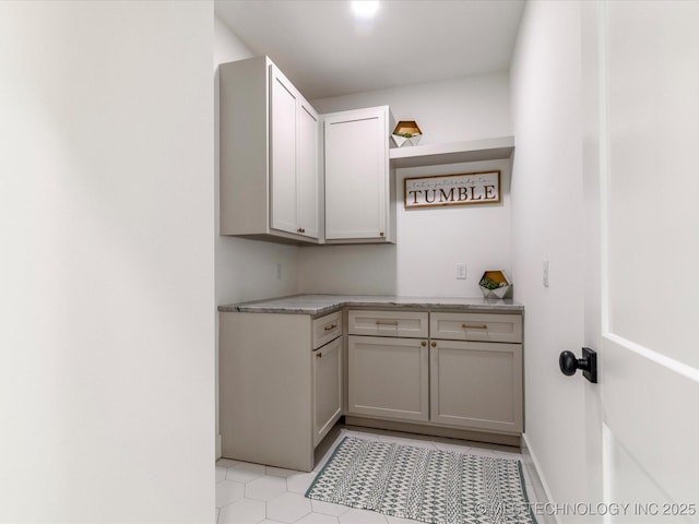 laundry area with light tile patterned flooring
