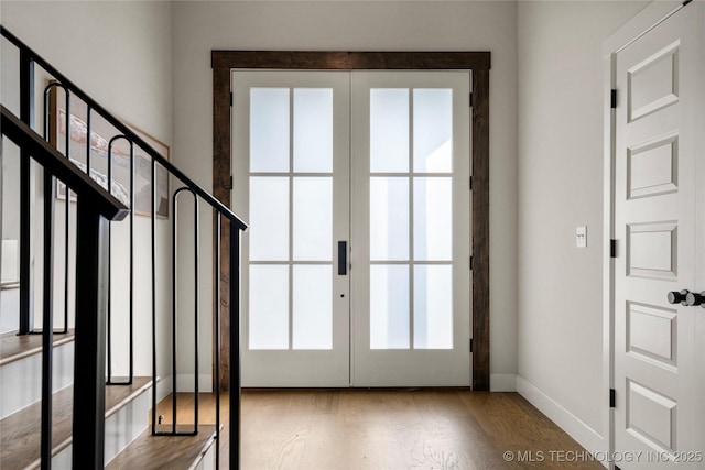 doorway to outside with baseboards, french doors, wood finished floors, and a wealth of natural light