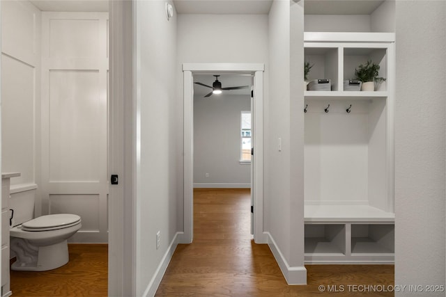 mudroom featuring wood finished floors, baseboards, and ceiling fan