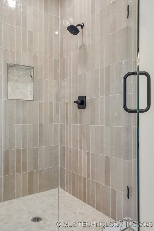 full bath with a shower stall
