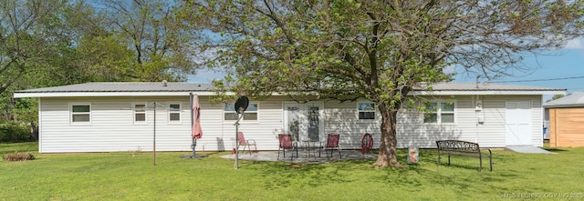 904 N Morningside Dr, Vinita, OK 74301 - back of house with a lawn, a patio, and metal roof