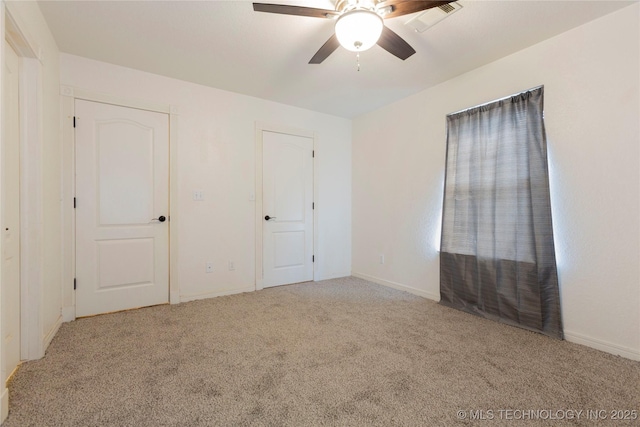 2202 Sycamore Rd, Mcalester, OK 74501 - unfurnished bedroom featuring visible vents, carpet flooring, baseboards, and a ceiling fan