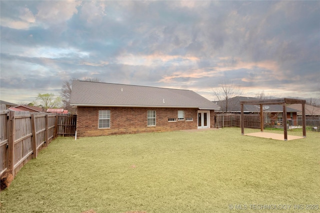 2202 Sycamore Rd, Mcalester, OK 74501 - yard at dusk featuring a fenced backyard, a pergola, and a patio