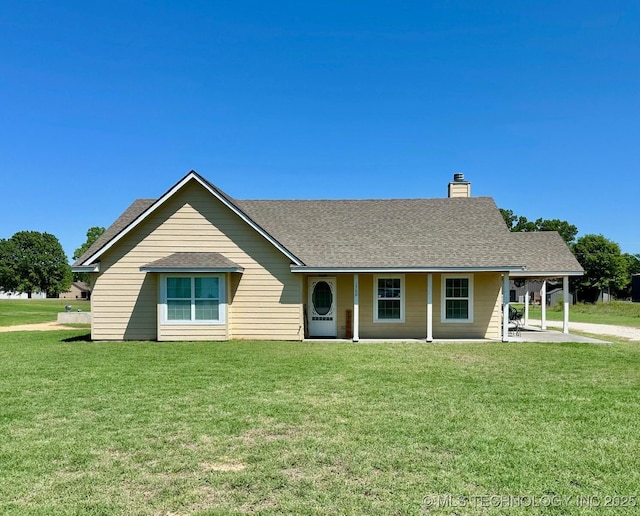 view of front of property featuring a front lawn, roof with shingles, and a chimney