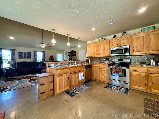 kitchen with visible vents, a peninsula, tasteful backsplash, appliances with stainless steel finishes, and open floor plan