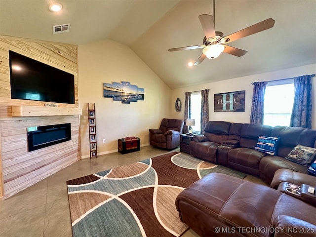 living area with lofted ceiling, visible vents, a ceiling fan, and a wealth of natural light