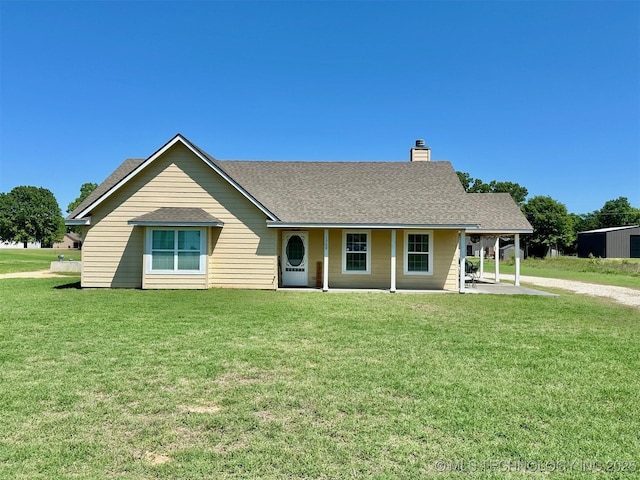 ranch-style house featuring a chimney, a front lawn, and roof with shingles