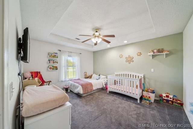 35041 Cohea Ln, Ketchum, OK 74331 - carpeted bedroom featuring ceiling fan, a tray ceiling, visible vents, and a textured ceiling