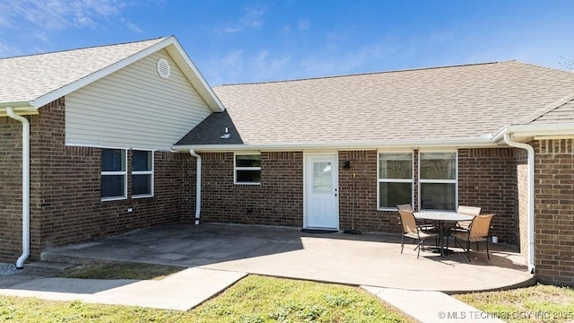 35041 Cohea Ln, Ketchum, OK 74331 - rear view of property featuring brick siding, roof with shingles, and a patio