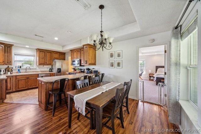 35041 Cohea Ln, Ketchum, OK 74331 - dining space featuring light wood-type flooring, visible vents, a healthy amount of sunlight, and an inviting chandelier