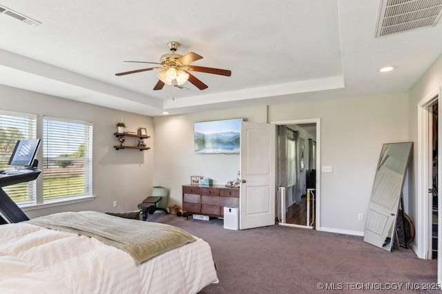 35041 Cohea Ln, Ketchum, OK 74331 - bedroom with dark carpet, visible vents, and a raised ceiling