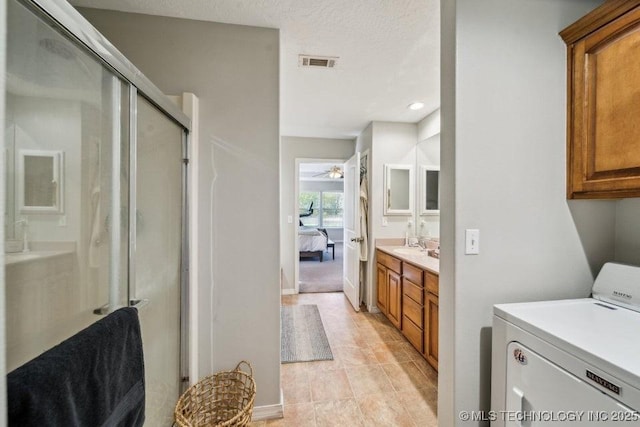 35041 Cohea Ln, Ketchum, OK 74331 - bathroom featuring ceiling fan, visible vents, a stall shower, ensuite bathroom, and washer / clothes dryer