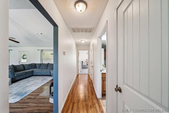 35041 Cohea Ln, Ketchum, OK 74331 - corridor featuring light wood-style flooring, visible vents, and baseboards