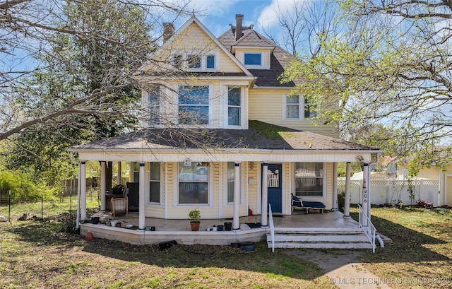 view of front of home featuring fence, a porch, and roof with shingles