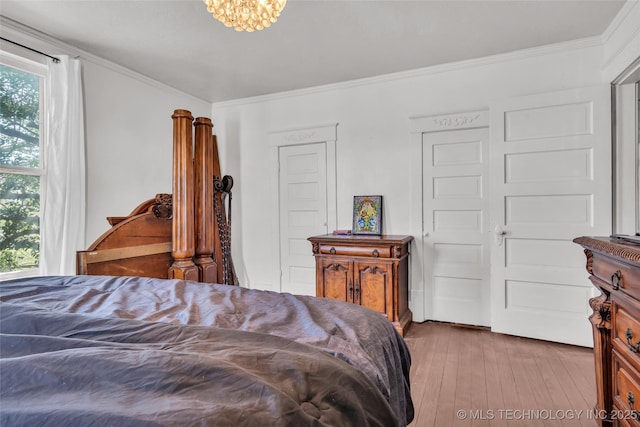 bedroom featuring wood-type flooring and ornamental molding