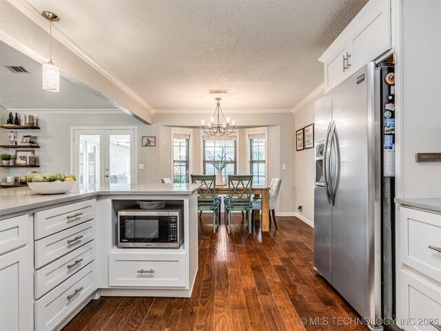 kitchen featuring a textured ceiling, visible vents, white cabinetry, a notable chandelier, and appliances with stainless steel finishes