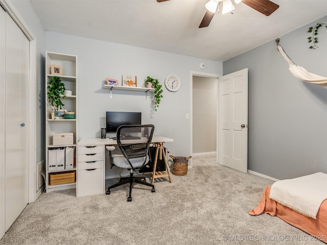 office space with ceiling fan and carpet