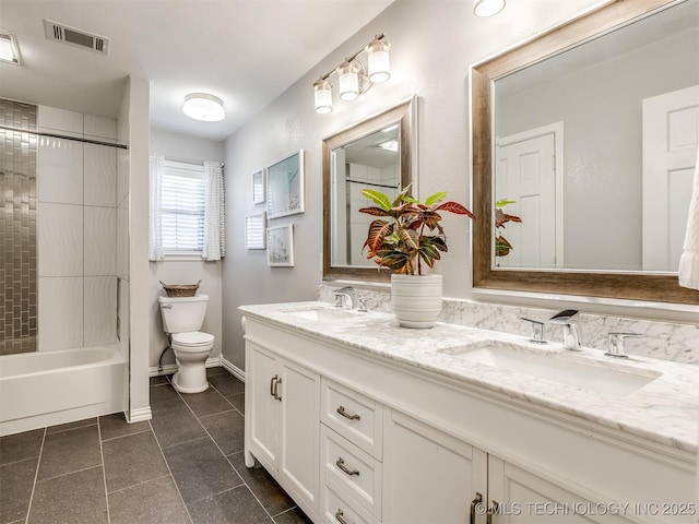 full bathroom featuring a sink, double vanity, visible vents, toilet, and tile patterned flooring
