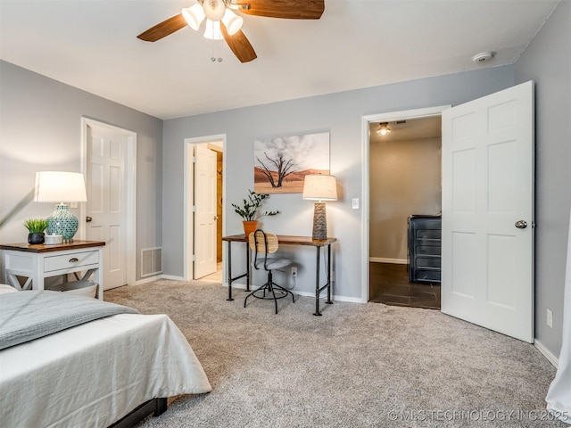bedroom with baseboards, visible vents, ceiling fan, and carpet