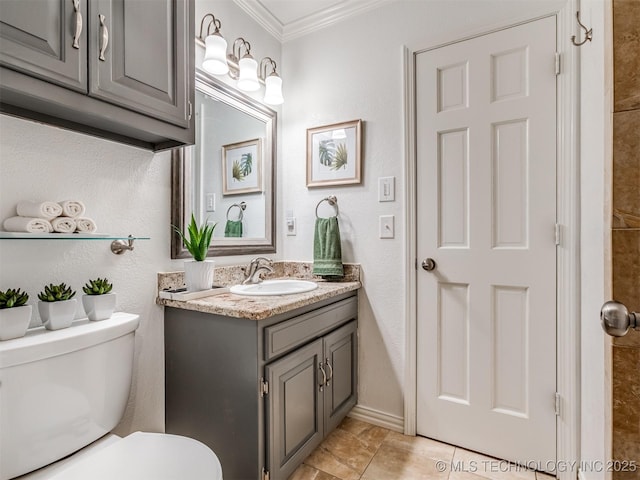 bathroom with ornamental molding, toilet, and vanity