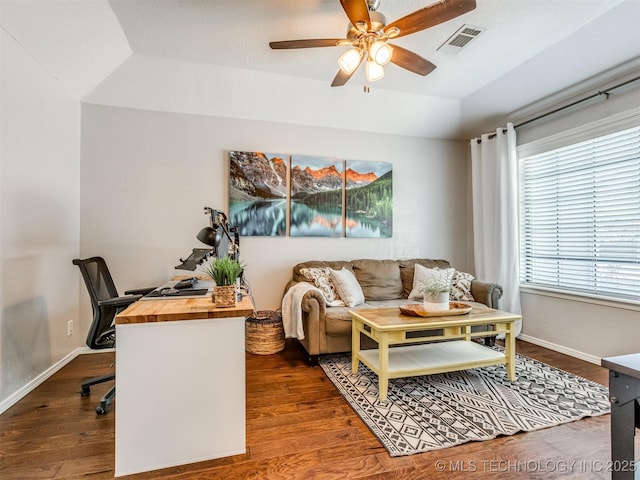 living room with visible vents, ceiling fan, baseboards, vaulted ceiling, and dark wood finished floors