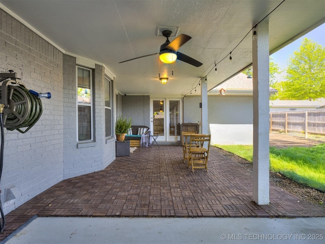 view of patio / terrace featuring ceiling fan and fence