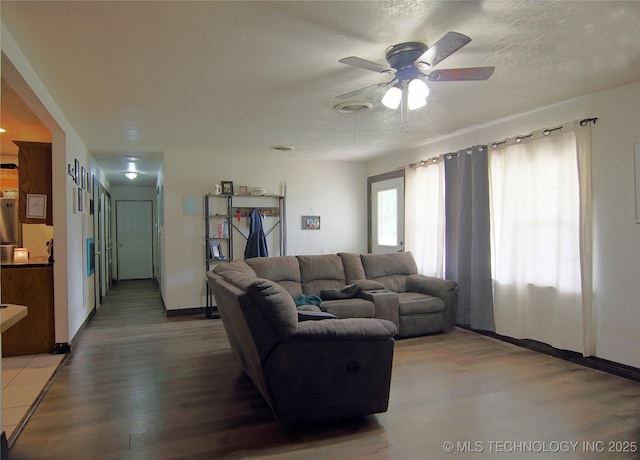705 S Garfield Ave, Wagoner, OK 74467 - living room with a textured ceiling, ceiling fan, and light wood-style flooring