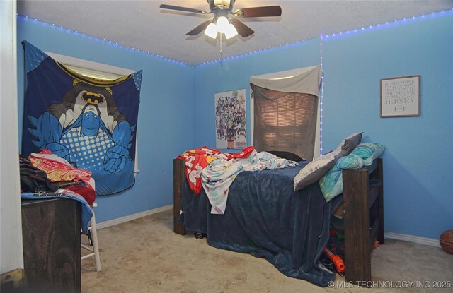 705 S Garfield Ave, Wagoner, OK 74467 - bedroom featuring baseboards, ceiling fan, and carpet