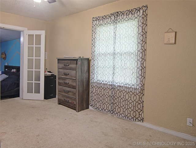 705 S Garfield Ave, Wagoner, OK 74467 - bedroom featuring carpet flooring, multiple windows, and a textured wall