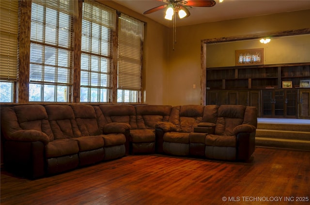 living area featuring plenty of natural light, a ceiling fan, and wood finished floors