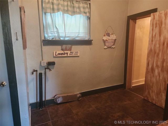 clothes washing area featuring tile patterned floors