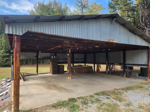 exterior space featuring a pole building and a carport