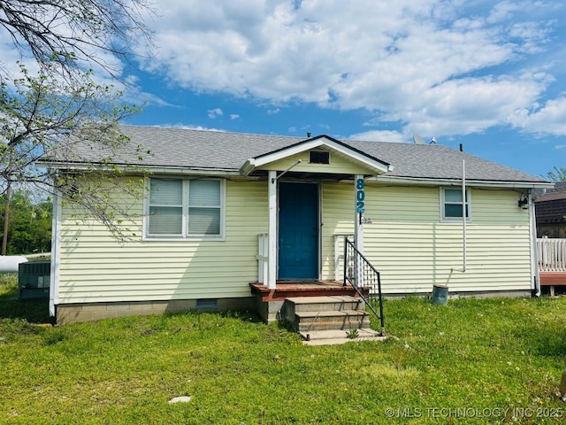 bungalow-style house featuring roof with shingles, crawl space, and a front lawn