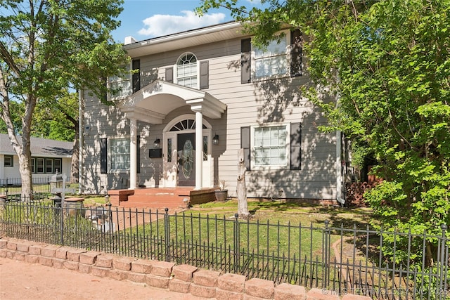 view of front of house featuring a front yard and a fenced front yard